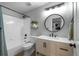 Bathroom featuring a tub and shower combo, modern mirror, and neutral vanity at 5010 Ox Trl, Parker, CO 80134