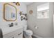 Charming half bathroom featuring shiplap walls, decorative mirror, and updated fixtures at 5010 Ox Trl, Parker, CO 80134