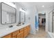 Bright bathroom with double sinks, vanity, tile floors, and a walk-in closet at 5010 Ox Trl, Parker, CO 80134