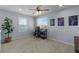 Bright bedroom with a ceiling fan, ample natural light, and neutral carpet at 5010 Ox Trl, Parker, CO 80134