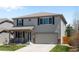 Charming two-story home with a well-manicured lawn and inviting curb appeal at 5010 Ox Trl, Parker, CO 80134