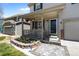 Inviting front porch with a welcome sign, lovely landscaping, and charming decorative details at 5010 Ox Trl, Parker, CO 80134