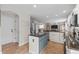 Spacious kitchen featuring a granite countertop island, stainless steel refrigerator, and open layout at 5010 Ox Trl, Parker, CO 80134