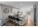Modern kitchen boasts granite countertops, island with seating, and stainless steel appliances at 5010 Ox Trl, Parker, CO 80134