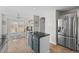 Bright kitchen featuring a granite countertop island, stainless steel refrigerator, and dining area at 5010 Ox Trl, Parker, CO 80134