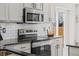 Stylish kitchen showcasing stainless steel appliances, white subway tile backsplash, and ample cabinetry at 5010 Ox Trl, Parker, CO 80134