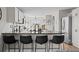 Bright kitchen features a granite countertop, stainless steel refrigerator, and modern design at 5010 Ox Trl, Parker, CO 80134