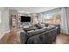 Comfortable living room with a large TV, built-in shelving, and stylish gray sofa at 5010 Ox Trl, Parker, CO 80134