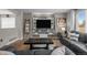 Well-lit living room with a cozy sofa, a large entertainment center, and a decorative ladder at 5010 Ox Trl, Parker, CO 80134