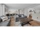 Open-concept living space with a modern kitchen, hardwood floors, and stylish furniture at 5010 Ox Trl, Parker, CO 80134