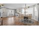 Open living and dining space with hardwood floors, ample natural light, and modern decorative touches at 5010 Ox Trl, Parker, CO 80134