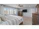 This main bedroom boasts natural light, a flatscreen TV, neutral colors, and ceiling fan at 5010 Ox Trl, Parker, CO 80134
