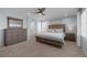 Spacious main bedroom features a large bed, wooden furniture, ceiling fan, and ample natural light at 5010 Ox Trl, Parker, CO 80134