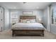 Bright main bedroom featuring a wooden bed with white and blue bedding, side tables, and a ceiling fan at 5010 Ox Trl, Parker, CO 80134