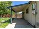 Covered back patio with wood posts offers an outdoor space for relaxation and enjoying the backyard view at 3735 S Lewiston St, Aurora, CO 80013