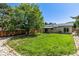 Large backyard with a privacy fence, green lawn, and solar panels on the house for energy efficiency at 3735 S Lewiston St, Aurora, CO 80013