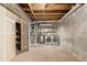 Unfinished basement area featuring concrete walls, wood framing, and laundry facilities at 3735 S Lewiston St, Aurora, CO 80013