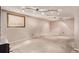 Finished basement area with cozy carpeting, track lighting, and a window for natural light at 3735 S Lewiston St, Aurora, CO 80013