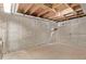 Unfinished basement area with concrete foundation and wooden ceiling, ready for your customization at 3735 S Lewiston St, Aurora, CO 80013