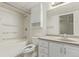 This clean bathroom features tile floors, a shower and tub, and a vanity with storage at 3735 S Lewiston St, Aurora, CO 80013