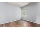 Bedroom featuring stylish wood floors, neutral walls, and a bright window at 3735 S Lewiston St, Aurora, CO 80013