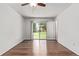 Sunlit bedroom with modern ceiling fan and sliding glass door to backyard at 3735 S Lewiston St, Aurora, CO 80013