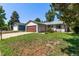 Charming single-story home featuring a large garage, well-maintained lawn, and colorful flower beds at 3735 S Lewiston St, Aurora, CO 80013