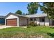 Charming single-story home featuring a large garage, well-maintained lawn, and colorful flower beds at 3735 S Lewiston St, Aurora, CO 80013