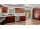 Renovated kitchen with wood cabinets, granite countertops, and stainless steel appliances with backyard access at 3735 S Lewiston St, Aurora, CO 80013