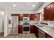 This updated kitchen features stainless steel appliances, granite countertops and wood-style flooring at 3735 S Lewiston St, Aurora, CO 80013