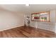 Bright living room with hardwood floors and an open view into the modern kitchen at 3735 S Lewiston St, Aurora, CO 80013