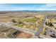 Aerial view of a park with trails, landscaping, a pond, and mountain views in the distance at 6707 6Th St, Frederick, CO 80530