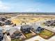 Aerial view showcases neighborhood with community park, nearby houses, and open spaces at 6707 6Th St, Frederick, CO 80530