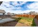 An expansive backyard with a cement slab is enclosed by a wooden fence at 6707 6Th St, Frederick, CO 80530