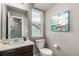 Well-lit half-bath with a modern sink, a decorative mirror, and a charming piece of sailboat art at 6707 6Th St, Frederick, CO 80530
