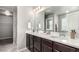 Double vanity with quartz countertops and modern dark wood cabinetry at 6707 6Th St, Frederick, CO 80530