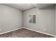 A simple bedroom boasts carpet flooring and a window letting in natural light at 6707 6Th St, Frederick, CO 80530