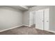 A bedroom showcases carpet floors, trim, and access to a closet and doorway at 6707 6Th St, Frederick, CO 80530