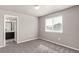 Comfortable carpeted bedroom with window and doorway to bathroom at 6707 6Th St, Frederick, CO 80530