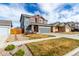 Well-kept two-story home with gray exterior, red accents, a two-car garage, and low-maintenance landscaping at 6707 6Th St, Frederick, CO 80530