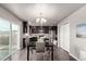 Modern kitchen featuring dark cabinets, stainless steel appliances, and an island with bar stool seating at 6707 6Th St, Frederick, CO 80530