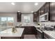Well-equipped kitchen with dark cabinetry, stainless steel appliances, and a view of the backyard at 6707 6Th St, Frederick, CO 80530