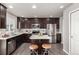 Beautiful kitchen featuring dark cabinets, stainless steel appliances, and an island with bar stool seating at 6707 6Th St, Frederick, CO 80530