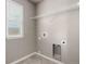 A dedicated laundry room features tile flooring, utility connections, and shelving at 6707 6Th St, Frederick, CO 80530