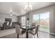 Bright open-plan living room with modern furnishings, a gray sofa, and adjacent dining area with backyard access at 6707 6Th St, Frederick, CO 80530