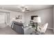 Comfortable living room with gray sofa, stylish decor, carpeted floors, and a ceiling fan at 6707 6Th St, Frederick, CO 80530