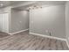 A spacious living room features wood-look floors, access to closet, and neutral walls at 6707 6Th St, Frederick, CO 80530
