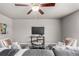 Cozy living room with plush seating, decorative pillows, a modern ceiling fan, and neutral-toned walls at 6707 6Th St, Frederick, CO 80530