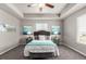 Comfortable primary bedroom featuring tray ceiling, plush carpeting, stylish decor, and ample natural light at 6707 6Th St, Frederick, CO 80530