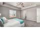Large primary bedroom with tray ceiling, plush carpeting, generous natural light, and an ensuite bathroom at 6707 6Th St, Frederick, CO 80530